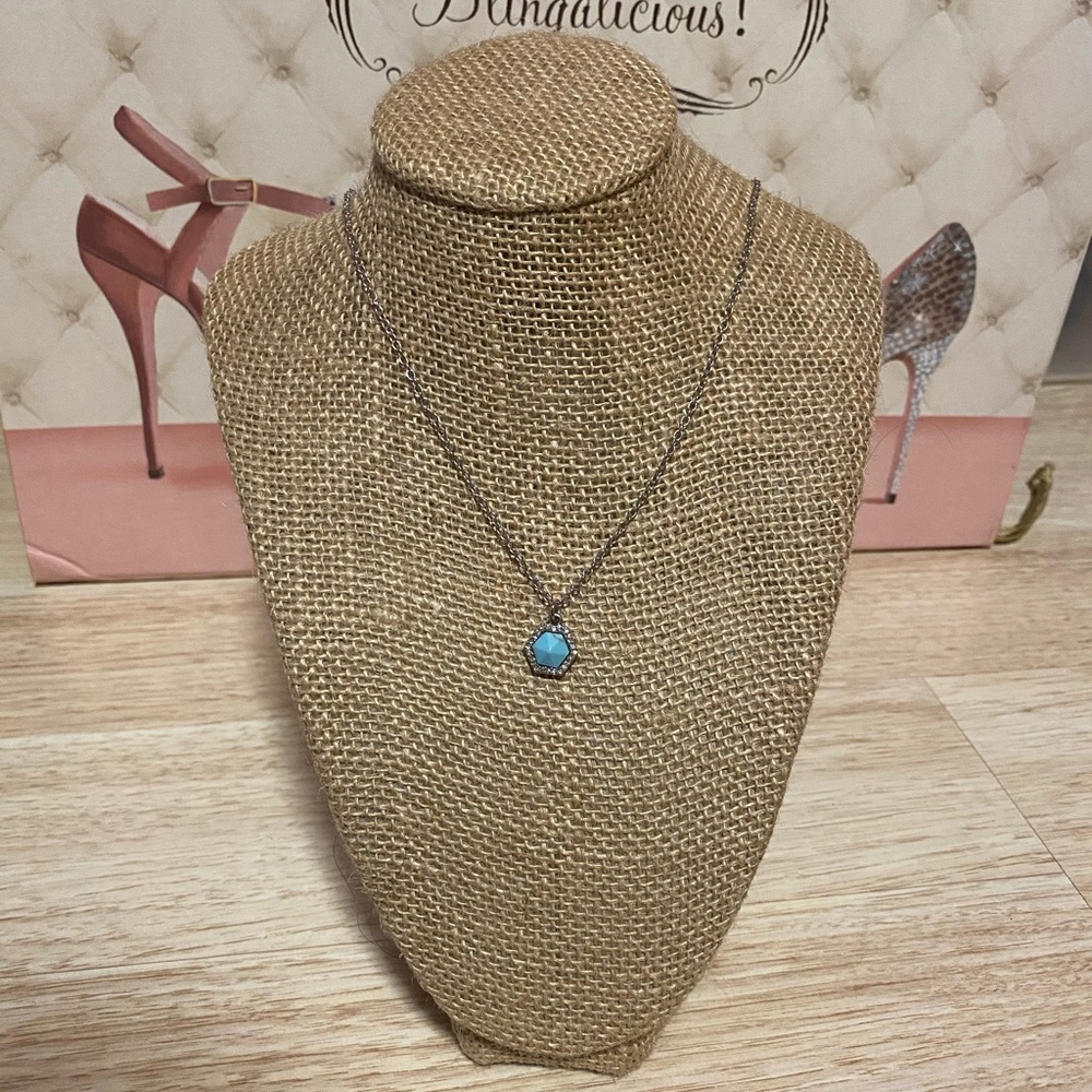 Small blue pendant surrounding cubic zirconium
